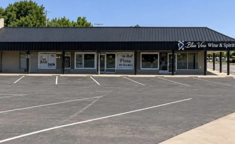 The existing strip frontage with mismatched tenant signage